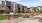 Modern apartment complex featuring stylish outdoor seating, lush greenery, and a barbecue area for social gatherings at Ona Natomas