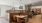 Elegant communal dining space with modern wooden accents, chic pendant lighting, and plush seating, offering a stylish and inviting atmosphere in Sacramento