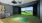 Luxurious home golf simulator room with HD projection screen and putting green, ideal for sports enthusiasts at Ona in Sacramento