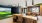 Luxurious communal lounge with sleek modern design, featuring a state-of-the-art golf simulator, stylish seating, and elegant pendant lighting at Ona in Natomas