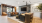 Modern and inviting living space featuring elegant gray sofas with orange accent pillows, sleek pendant lighting, and stylish artwork enhancing the cozy ambiance at Ona in Sacramento's Natomas neighborhood