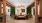 Luxurious living area featuring elegant seating, artistic wall decor, and vibrant indoor greenery creating a stylish, modern atmosphere at Ona in Natomas