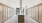 Elegant apartment mailroom featuring a modern chandelier, sleek tile flooring, and rows of secure mailboxes with a view to the outdoor courtyard at Ona in Natomas