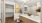 Elegant bathroom with dual sinks, modern wood cabinetry, stylish decor, and a spacious walk-in closet at Ona Natomas