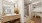 Elegant modern bathroom with a large mirror and wooden vanity, leading into a spacious closet with natural accents at Ona Natomas