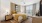 Elegant bedroom with cozy decor featuring a plush bed adorned with golden pillows and a textured throw, complemented by warm lighting and stylish artwork at Ona Natomas