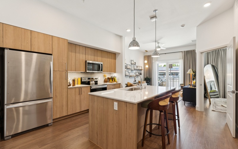a kitchen with stools and a table