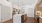Modern kitchen with sleek island, elegant lighting, and stylish wood cabinetry, offering a sophisticated living space at Ona Natomas