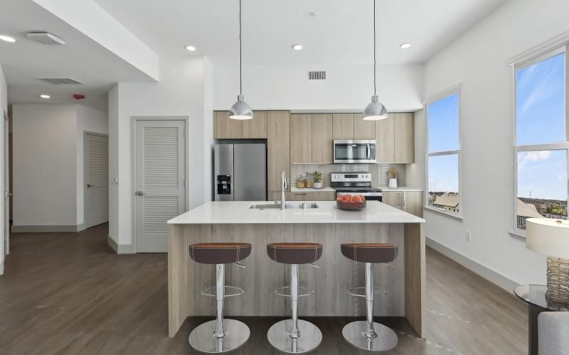 a kitchen with stools and a table